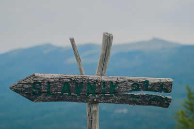 Low angle view of old wooden post against sky