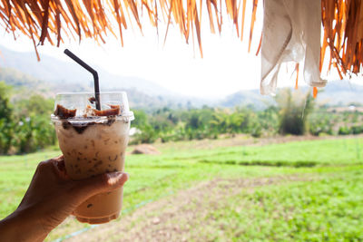 Close-up of hand holding drink