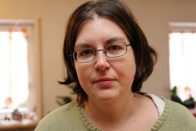 Close-up portrait of woman at home