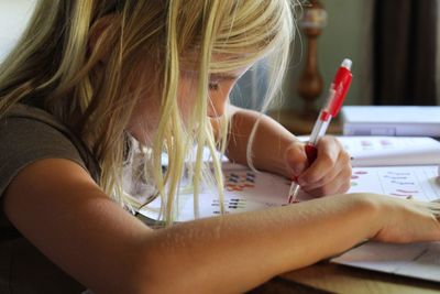 Close-up of girl studying at home