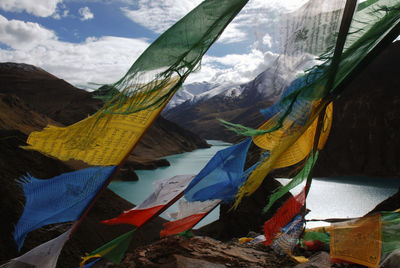 Close-up of prayer flags against mountains