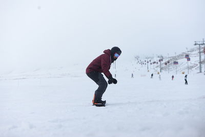 People skiing on snow covered landscape
