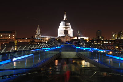 Illuminated buildings against sky at night