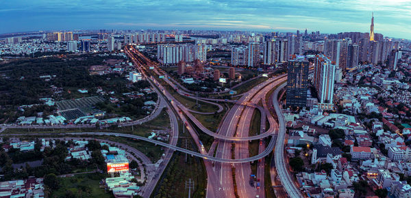 High angle view of city street and buildings against sky