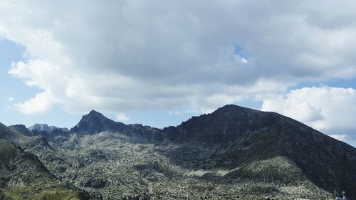 Scenic view of mountains against cloudy sky