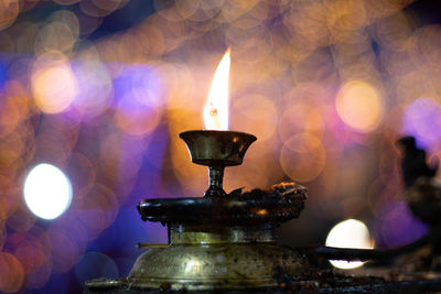 Close-up of illuminated candles in building