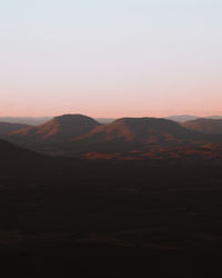 Scenic view of silhouette mountains against sky during sunset