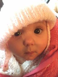 Close-up portrait of cute baby girl in snow