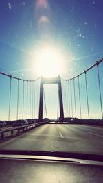 Suspension bridge seen through car windshield