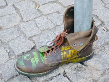 High angle view of shoes on footpath