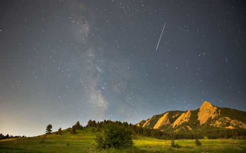 Scenic view of mountains against sky at night