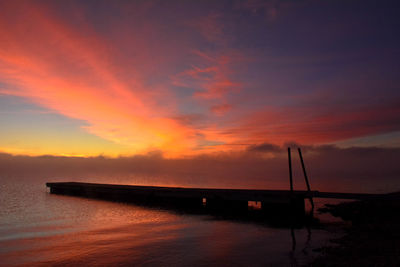 Scenic view of dramatic sky over sea during sunset