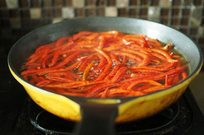 Close-up of red chilies in frying pan