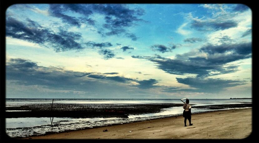 beach, sea, full length, sky, water, shore, lifestyles, leisure activity, horizon over water, standing, transfer print, rear view, tranquil scene, walking, cloud - sky, tranquility, beauty in nature, auto post production filter