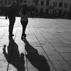 Shadow of woman on city street