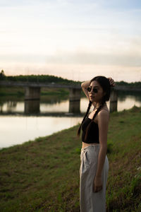 Portrait of woman standing against sky