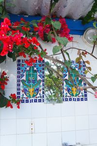 Low angle view of artificial flowers on wall