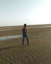 Full length of woman standing on beach