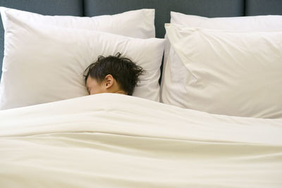 Child lying on bed