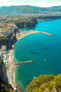 High angle view of sea and city