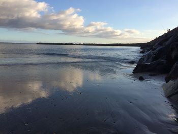 Scenic view of sea against cloudy sky