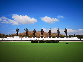 Statues against blue sky