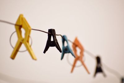 Close-up of clothespins hanging on clothesline