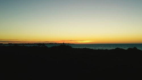 Scenic view of sea against clear sky during sunset