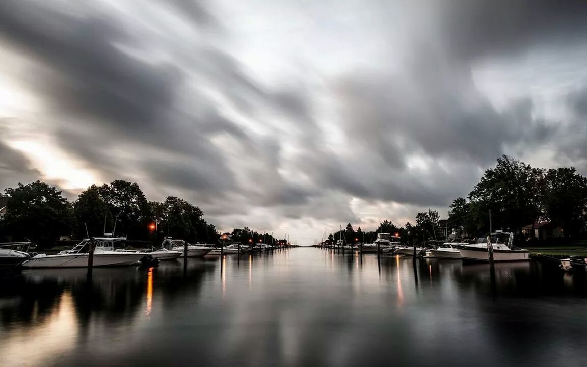 sky, water, cloud - sky, tree, cloudy, waterfront, reflection, tranquility, tranquil scene, cloud, scenics, lake, weather, nature, beauty in nature, overcast, dusk, nautical vessel, river, idyllic