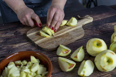 Women preparing delicious apple tart or pie .cutting apples or slicing