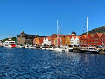 Sailboats in sea against clear blue sky