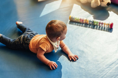 High angle view of boy playing on floor
