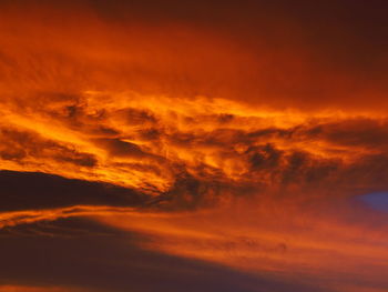 Low angle view of dramatic sky during sunrise