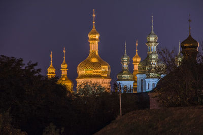 Illuminated buildings in city against sky