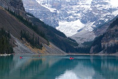 Scenic view of lake with snowcapped mountain in background