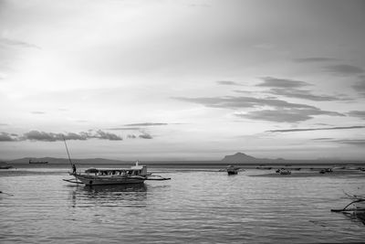 Boats in sea against sky