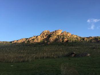 Scenic view of land against clear blue sky