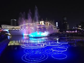 Illuminated ferris wheel at night