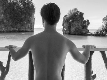 Rear view of shirtless boy in swimming pool