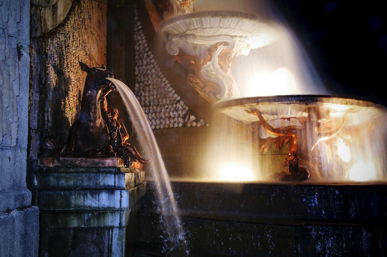 STATUE OF ILLUMINATED BUILDING IN WATER