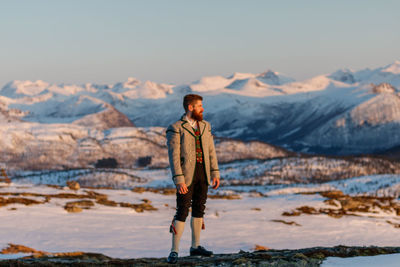 Full length of man standing on mountain against sky