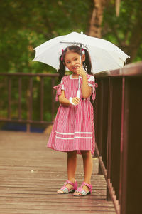 Full length of woman standing in rain