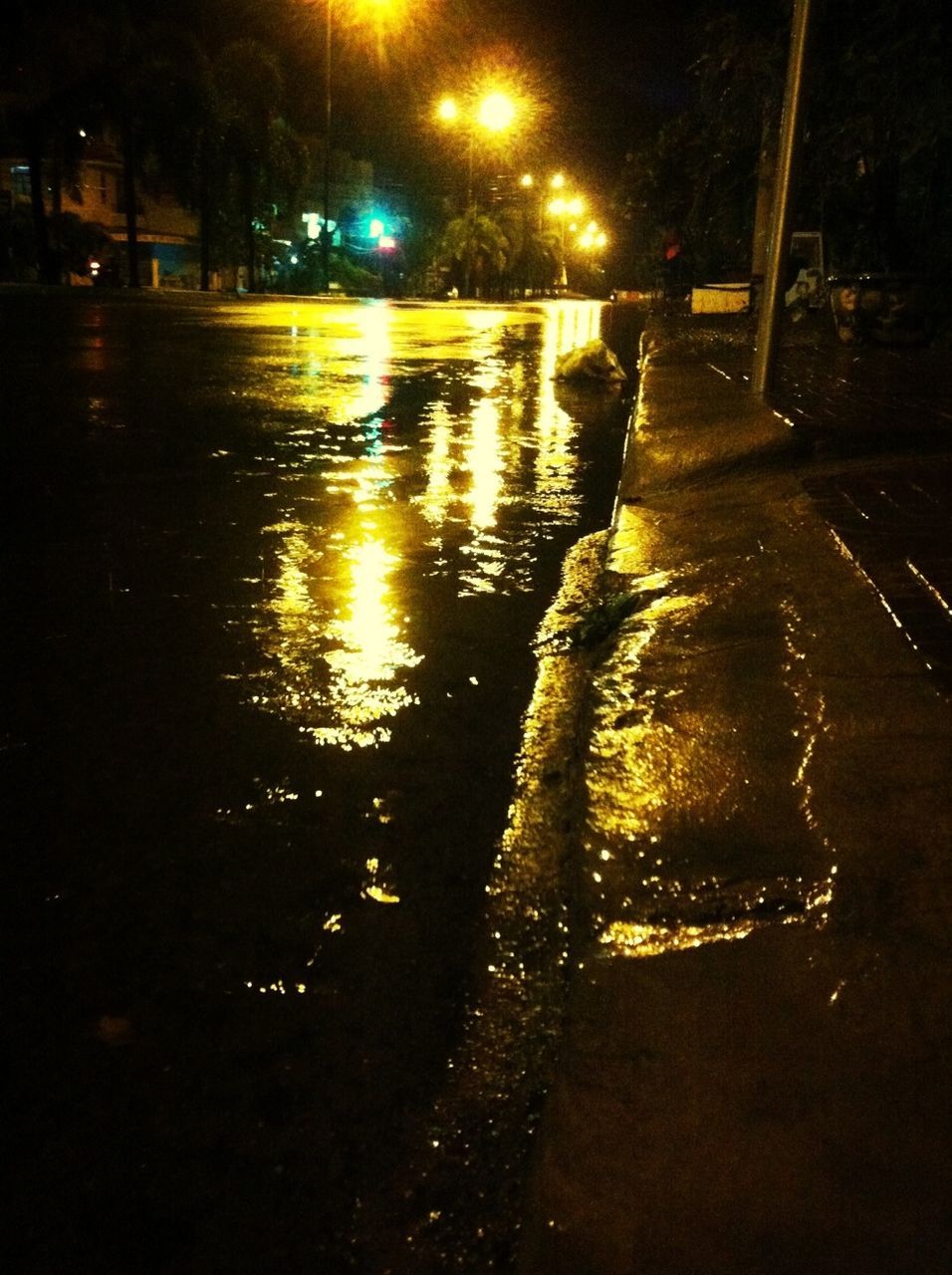 night, illuminated, street, street light, water, building exterior, the way forward, road, tree, outdoors, reflection, sidewalk, city, dark, wet, footpath, sunlight, no people, built structure, nature