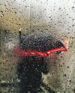 Close-up of wet glass window in rainy season