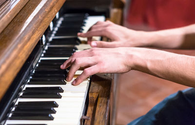 Close-up of hands playing piano