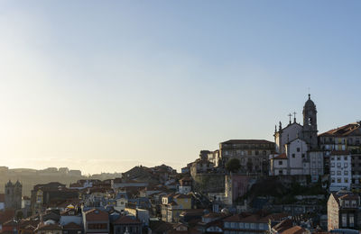 View of buildings in city against clear sky