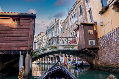 Riding a traditional gondola down the narrow canals in venice, italy.