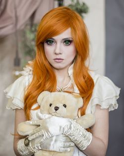 Young woman holding teddy bear