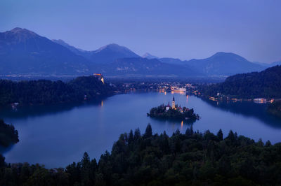 Scenic view of lake against sky at night