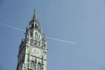 Low angle view of clock tower against clear blue sky